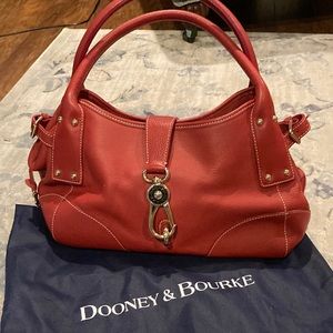 Dooney & Bourke handbag. Gorgeous RED with brass. Mint condition.